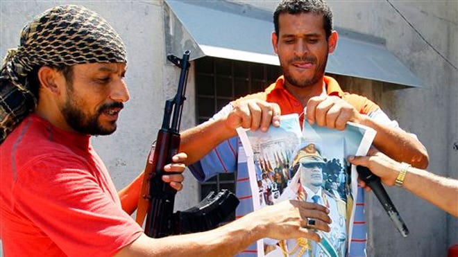 qaddafi_poster_tear